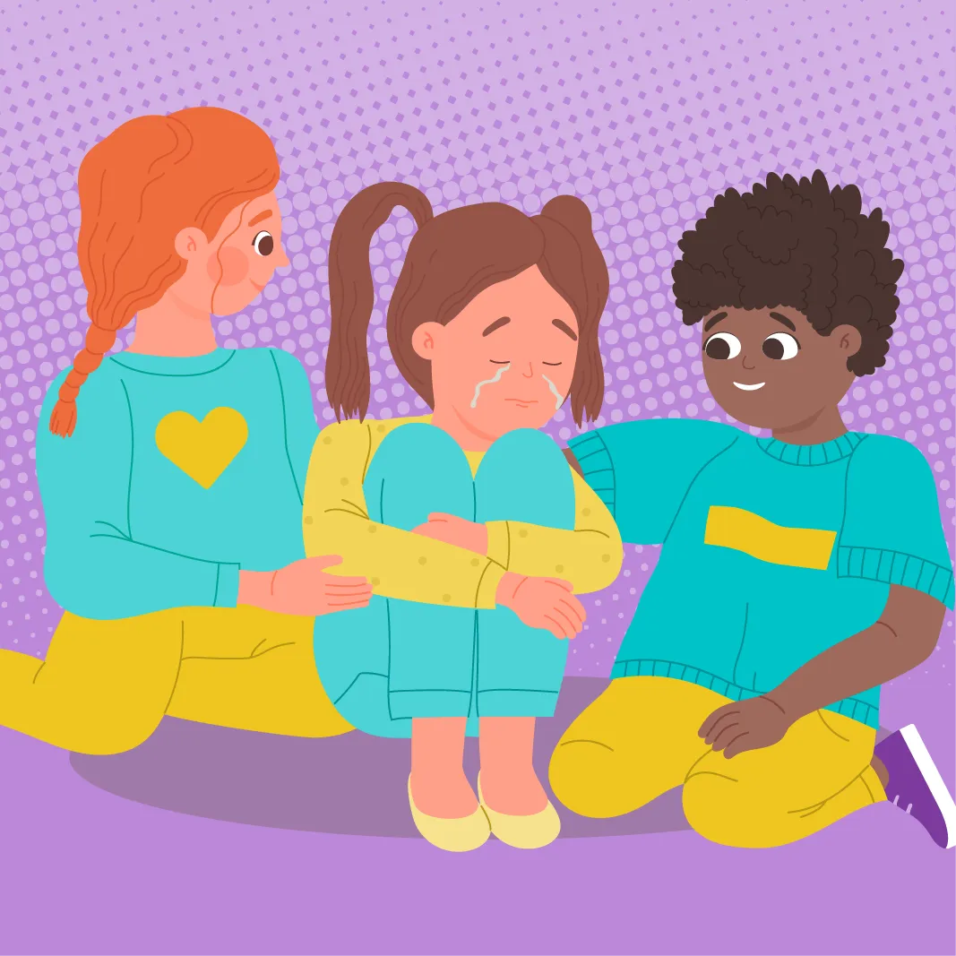Trois enfants sont assis par terre. L'enfant au centre semble triste et pleure, tandis que les deux autres enfants le réconfortent en posant une main sur ses épaules.